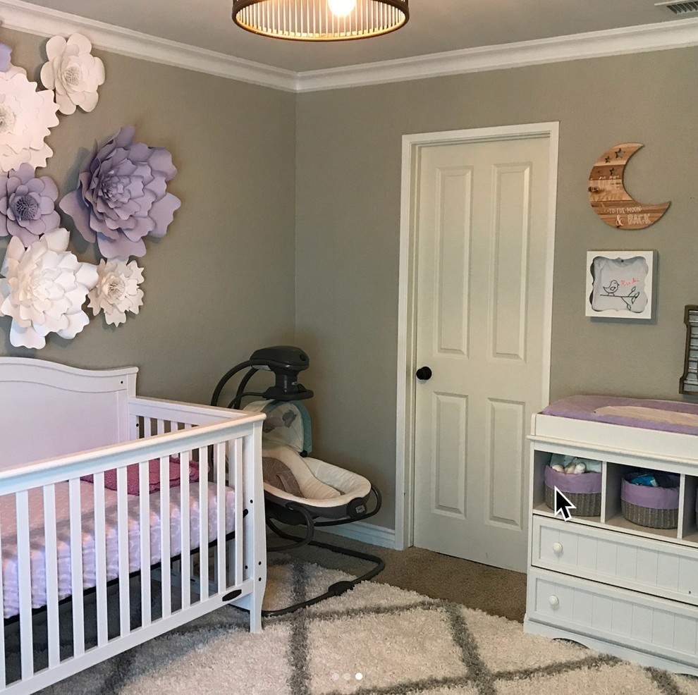Medium sized nursery for girls in Orange County with grey walls and carpet.