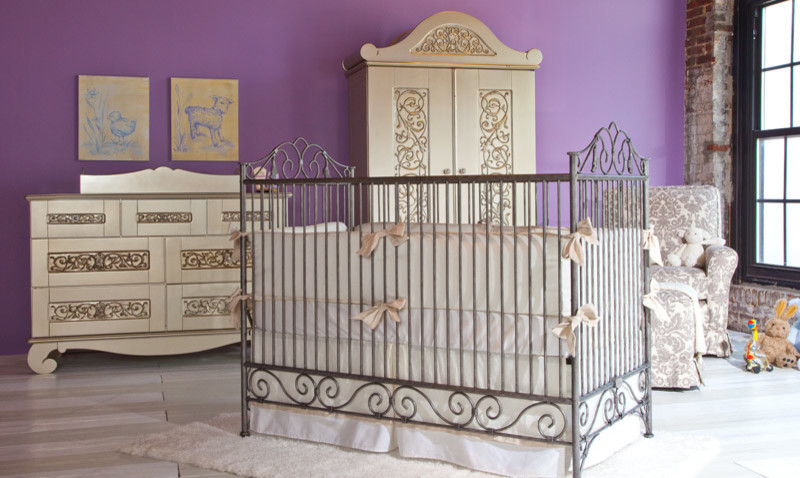 Cette image montre une chambre de bébé fille avec un mur violet et parquet clair.