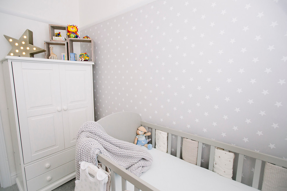 Small contemporary gender neutral nursery in London with grey walls and carpet.