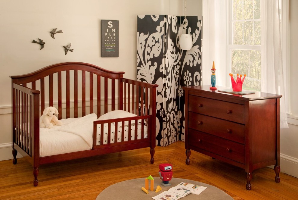 Nursery - mid-sized traditional gender-neutral medium tone wood floor nursery idea in Minneapolis with white walls