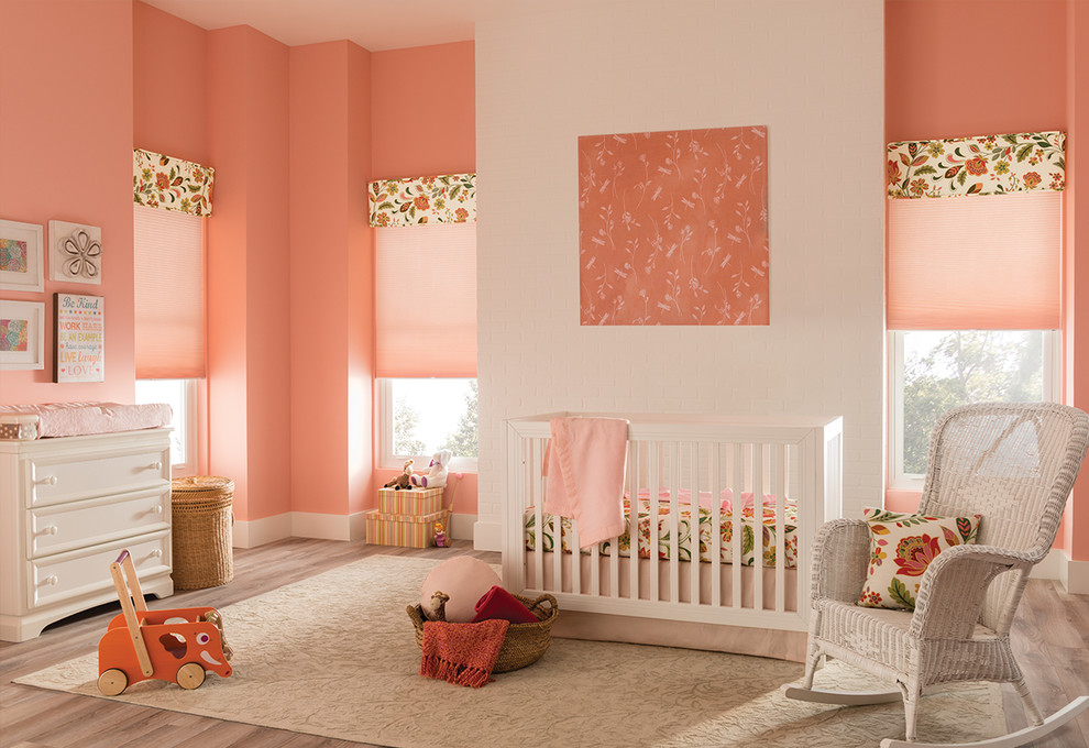 Idées déco pour une chambre de bébé fille classique avec un mur rose et parquet clair.