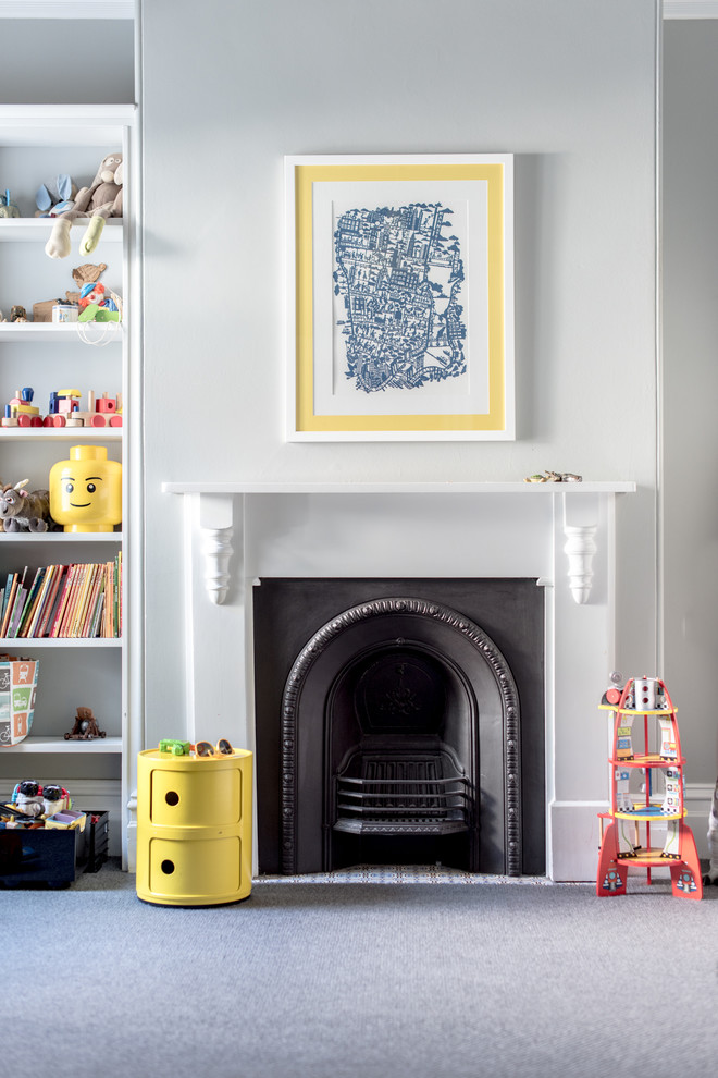 Photo of a large victorian nursery for boys in Sydney with grey walls, carpet, grey floors and a chimney breast.