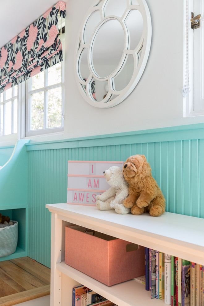 Modelo de habitación de bebé neutra contemporánea de tamaño medio con paredes beige y suelo de madera en tonos medios