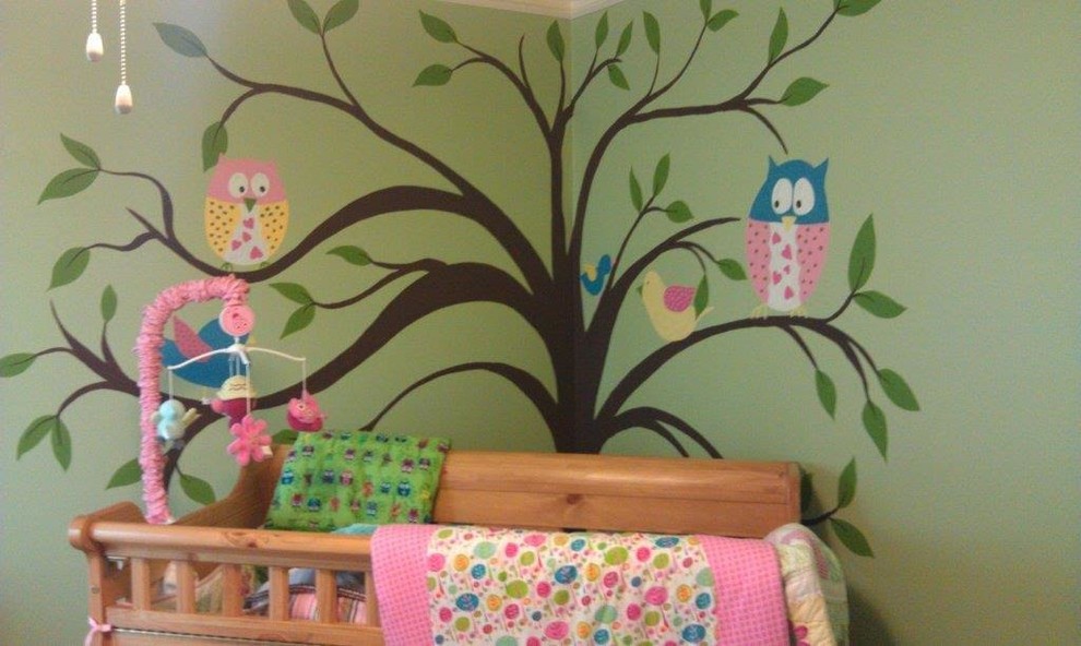 This is an example of a medium sized eclectic nursery for girls in Chicago with green walls.