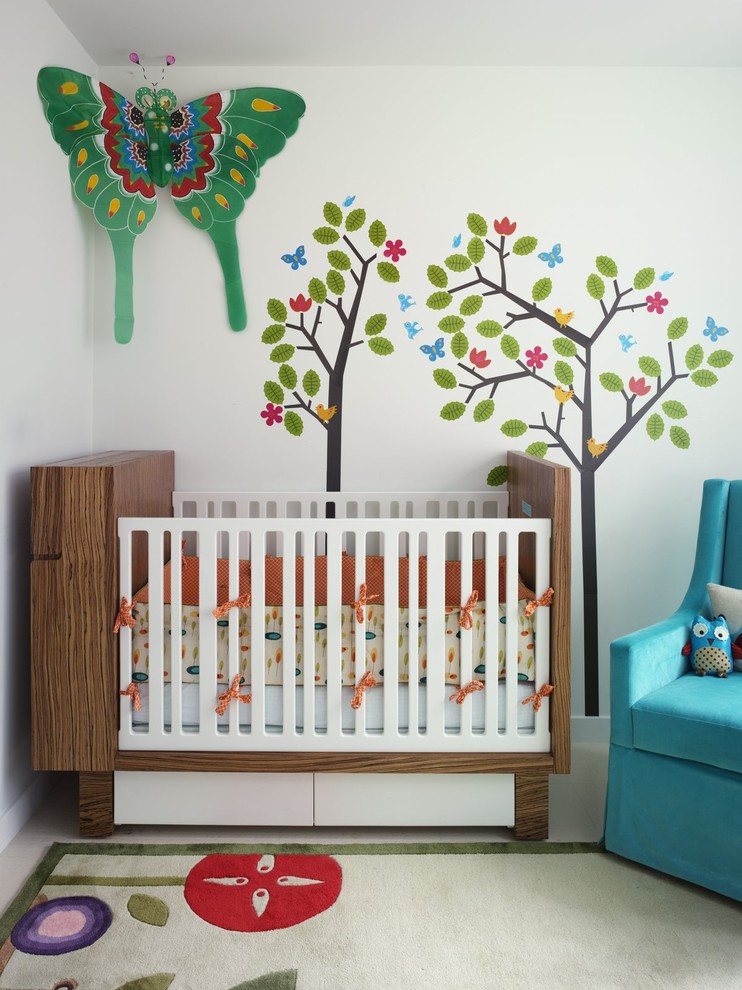 Example of an eclectic nursery design in New York with white walls