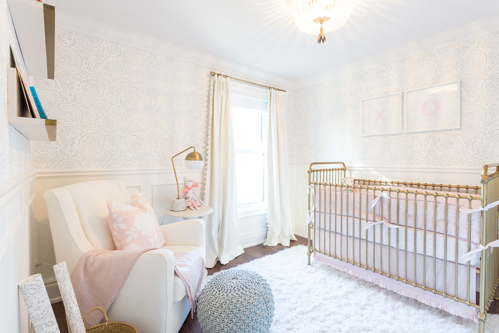 Large classic nursery for girls in Toronto with white walls, dark hardwood flooring and brown floors.