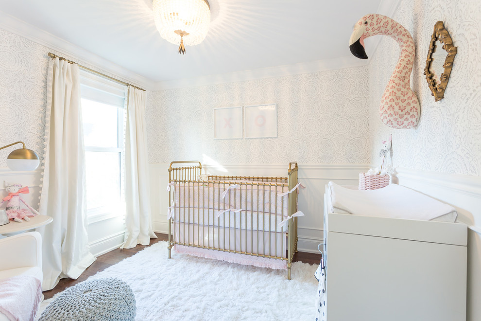 Inspiration for a large transitional girl dark wood floor and brown floor nursery remodel in Toronto with white walls