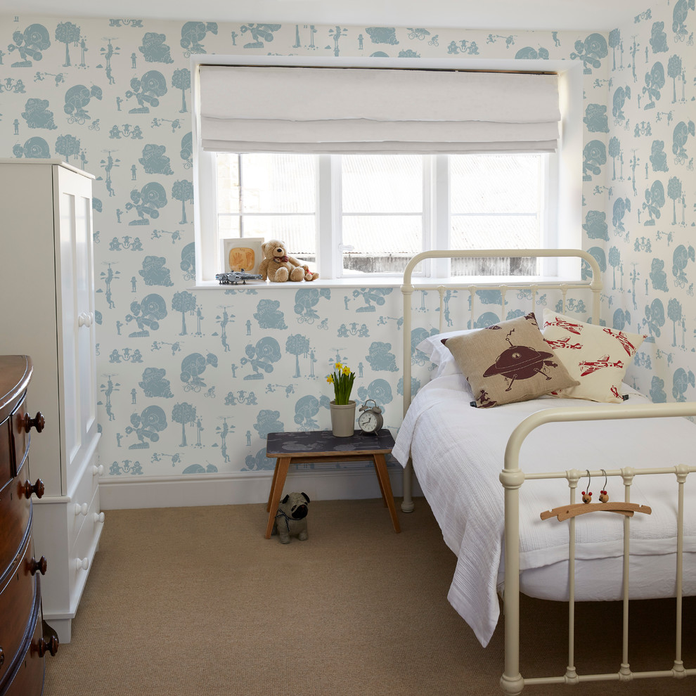 This is an example of a medium sized contemporary nursery for boys in Other with white walls and carpet.