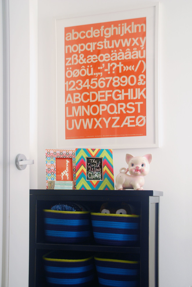 Design ideas for a medium sized eclectic nursery for boys in New York with white walls and dark hardwood flooring.