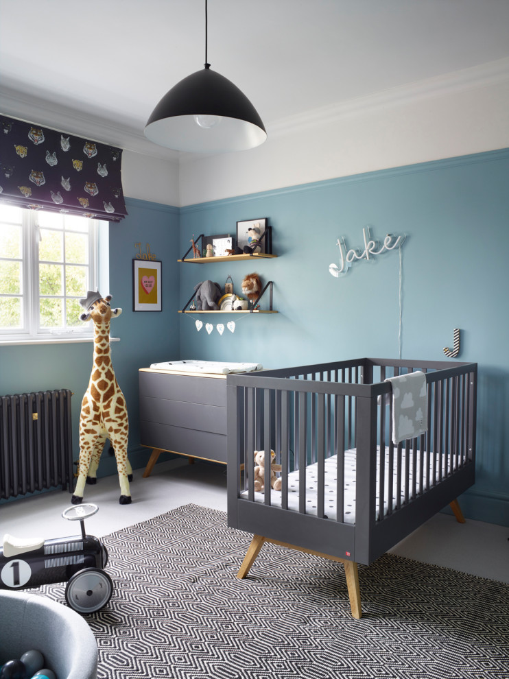 Large contemporary nursery for boys in Buckinghamshire with blue walls, grey floors and feature lighting.