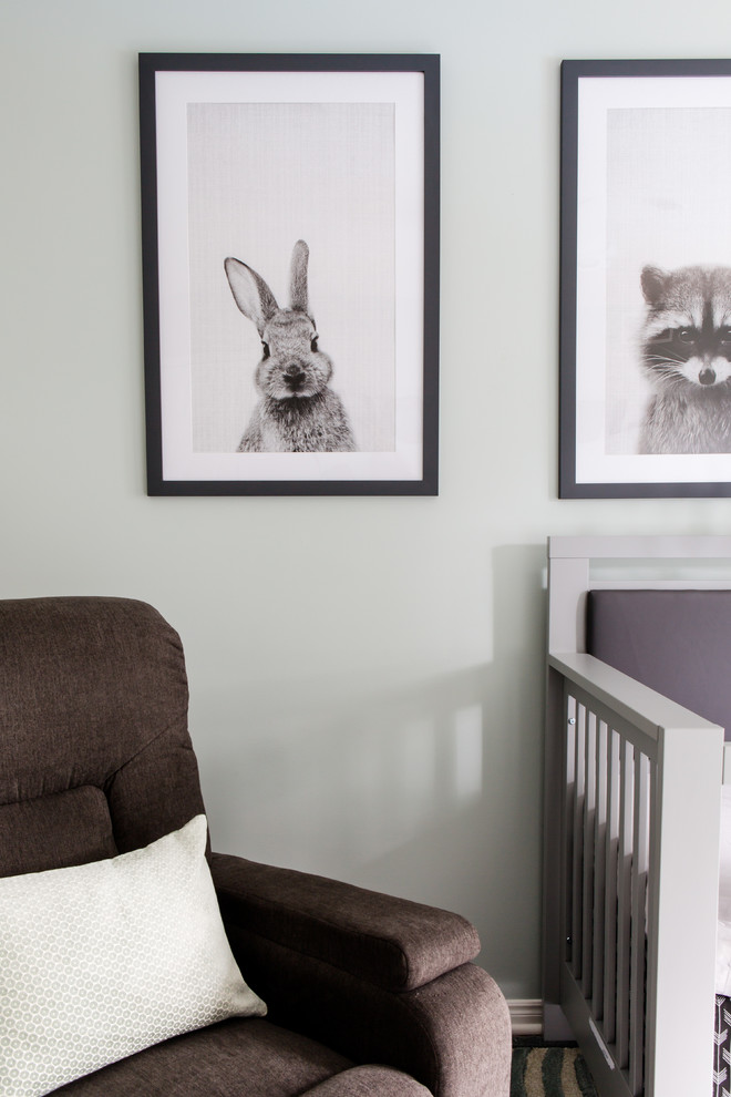 Photo of a medium sized modern nursery for boys in Toronto with green walls and light hardwood flooring.