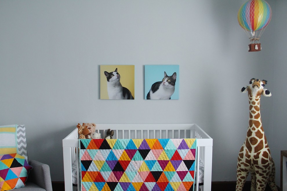 Inspiration for a mid-sized timeless gender-neutral dark wood floor nursery remodel in Indianapolis with gray walls
