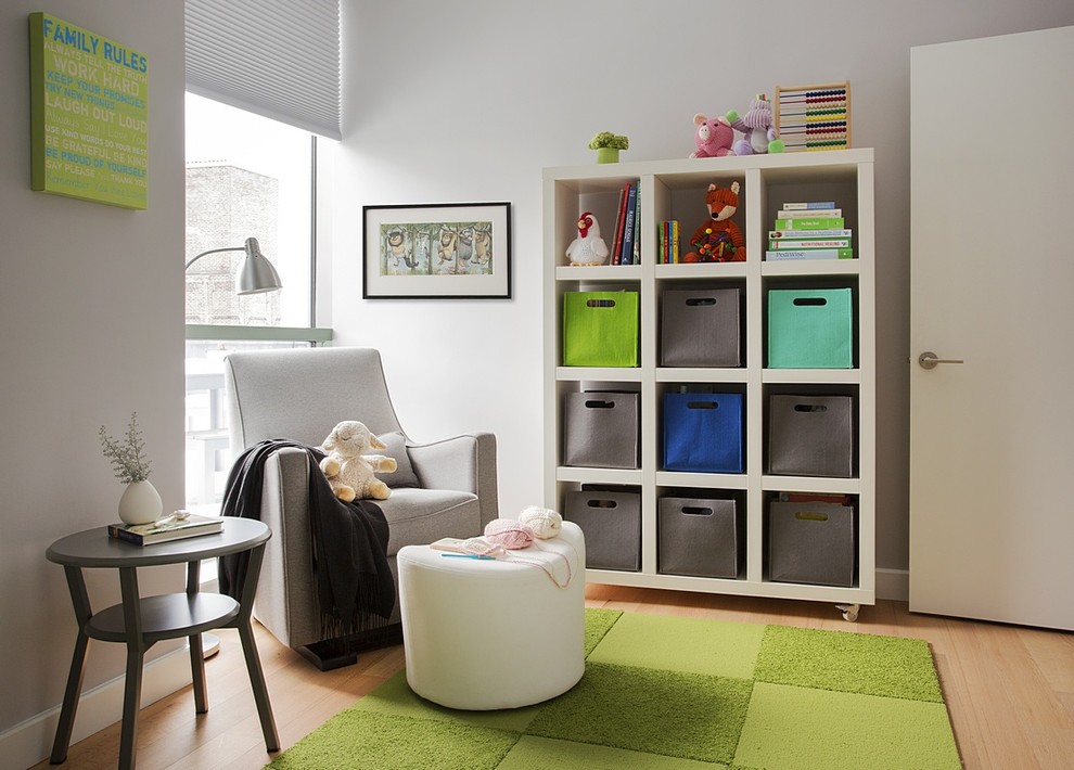 Inspiration for a mid-sized contemporary gender-neutral light wood floor nursery remodel in Boston with white walls