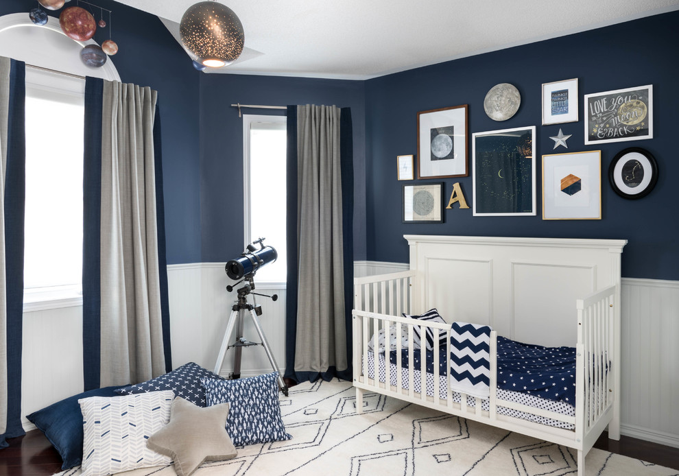 This is an example of a medium sized contemporary nursery for boys in Toronto with blue walls and carpet.