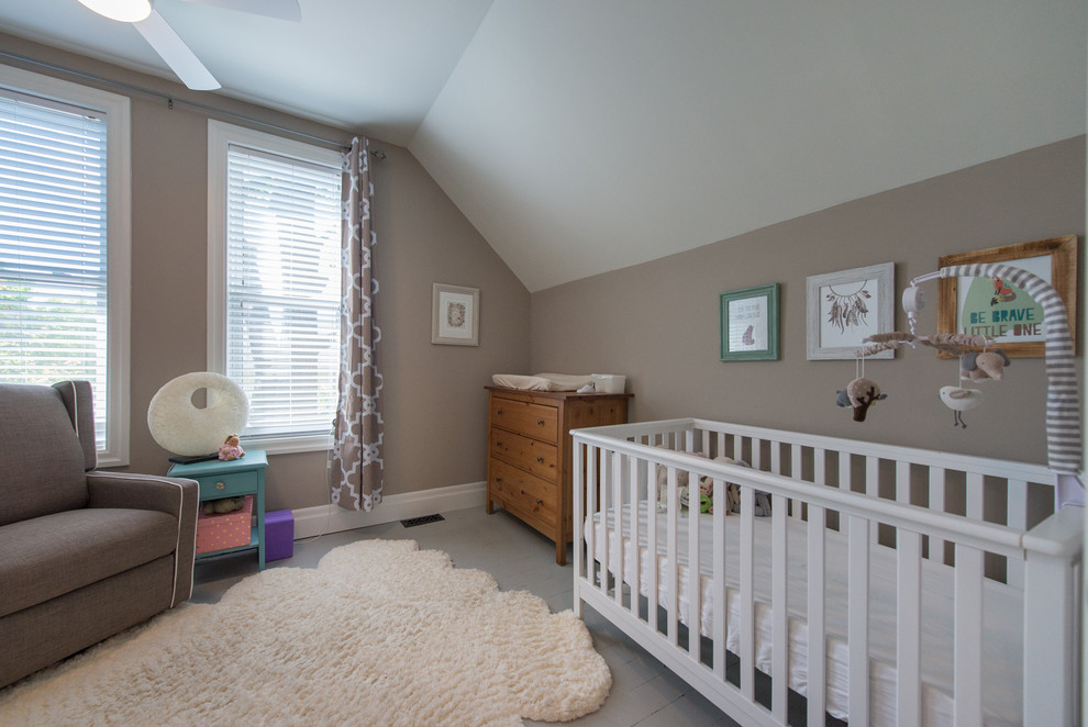 Medium sized classic gender neutral nursery in Toronto with beige walls, painted wood flooring and grey floors.