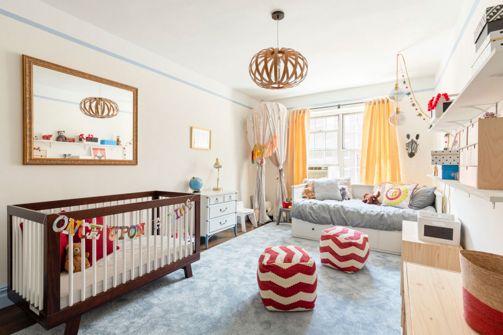 Photo of a medium sized traditional nursery in New York with white walls, medium hardwood flooring and brown floors.