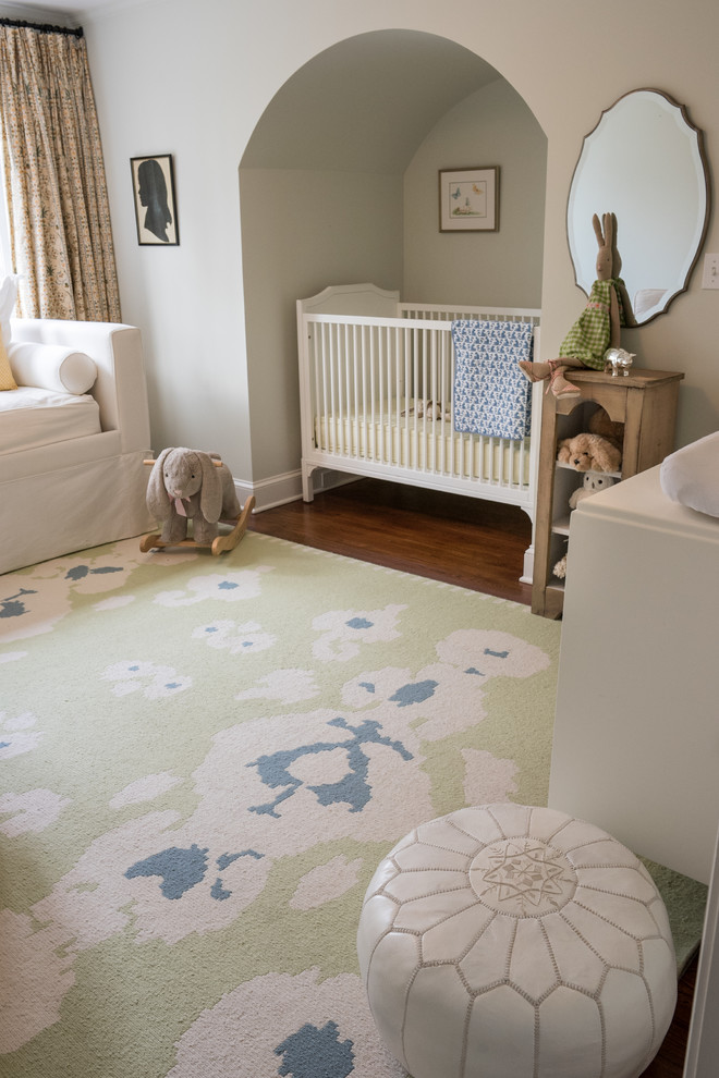 Mid-sized country girl medium tone wood floor nursery photo in New York with gray walls