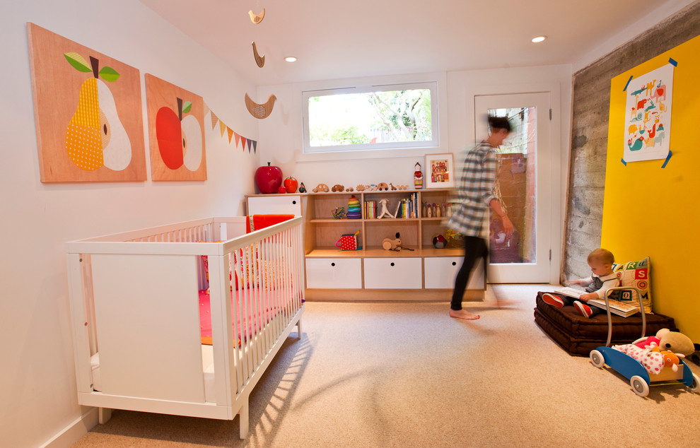 This is an example of a modern gender neutral nursery in San Francisco with white walls and carpet.