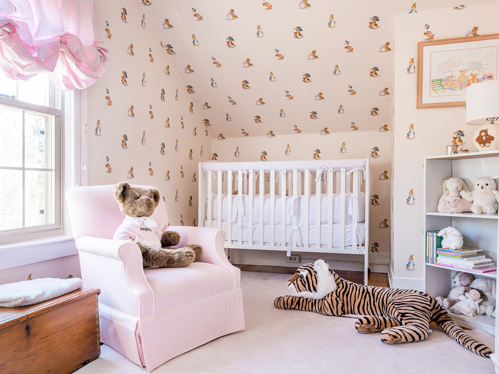 Design ideas for a farmhouse nursery in Boston with beige walls, medium hardwood flooring and pink floors.