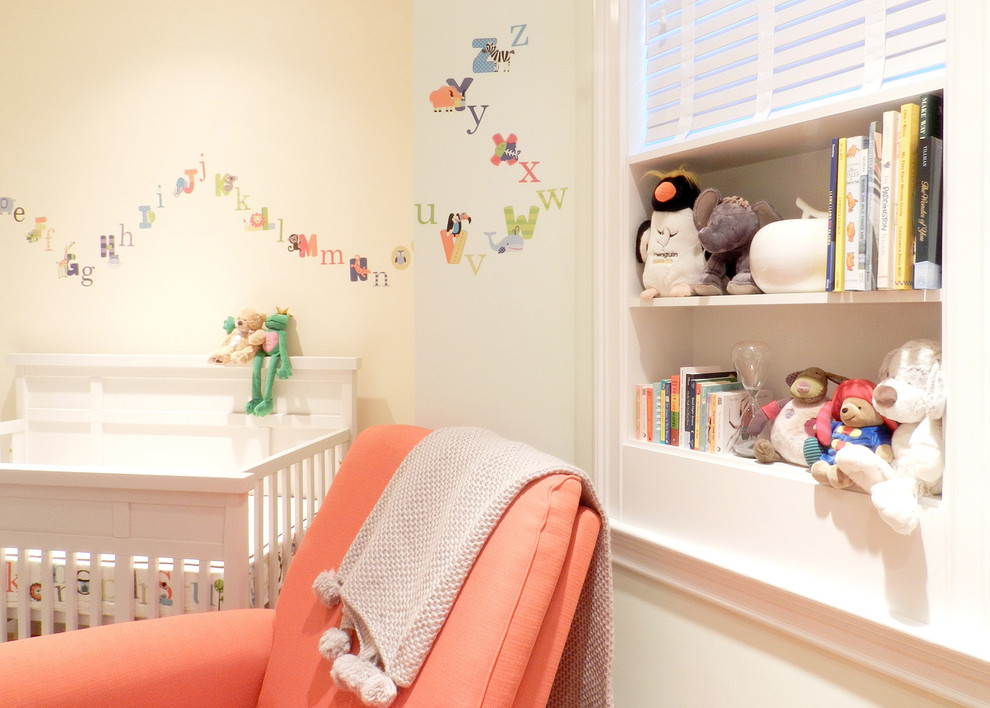 This is an example of a small classic gender neutral nursery in Boston with multi-coloured walls.