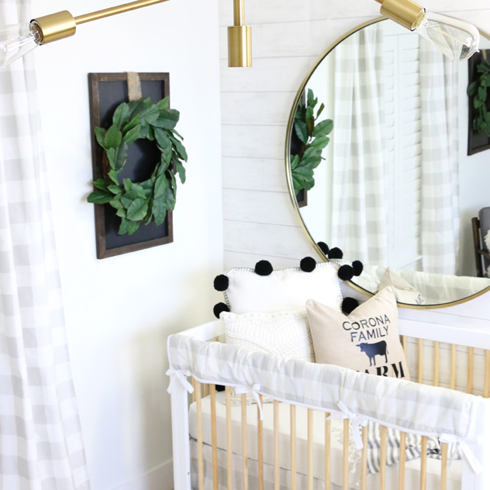 This is an example of a medium sized rural gender neutral nursery in Other with white walls.