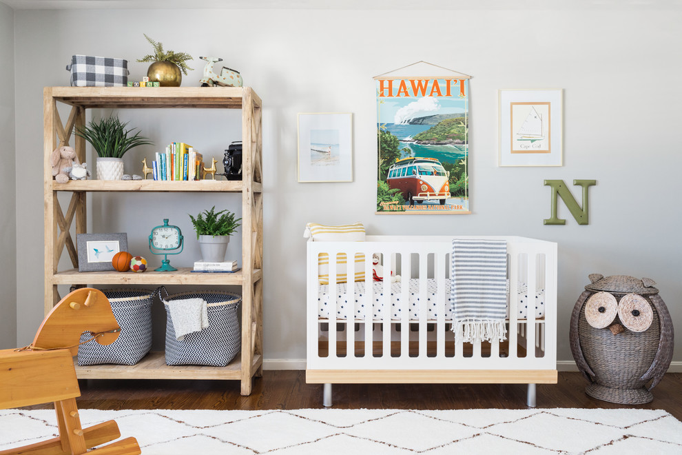 Inspiration for a contemporary boy dark wood floor and brown floor nursery remodel in Boston with white walls