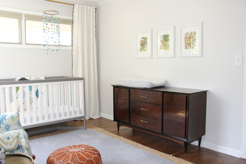 Inspiration pour une chambre de bébé neutre minimaliste de taille moyenne avec un mur gris, un sol en bois brun et un sol marron.