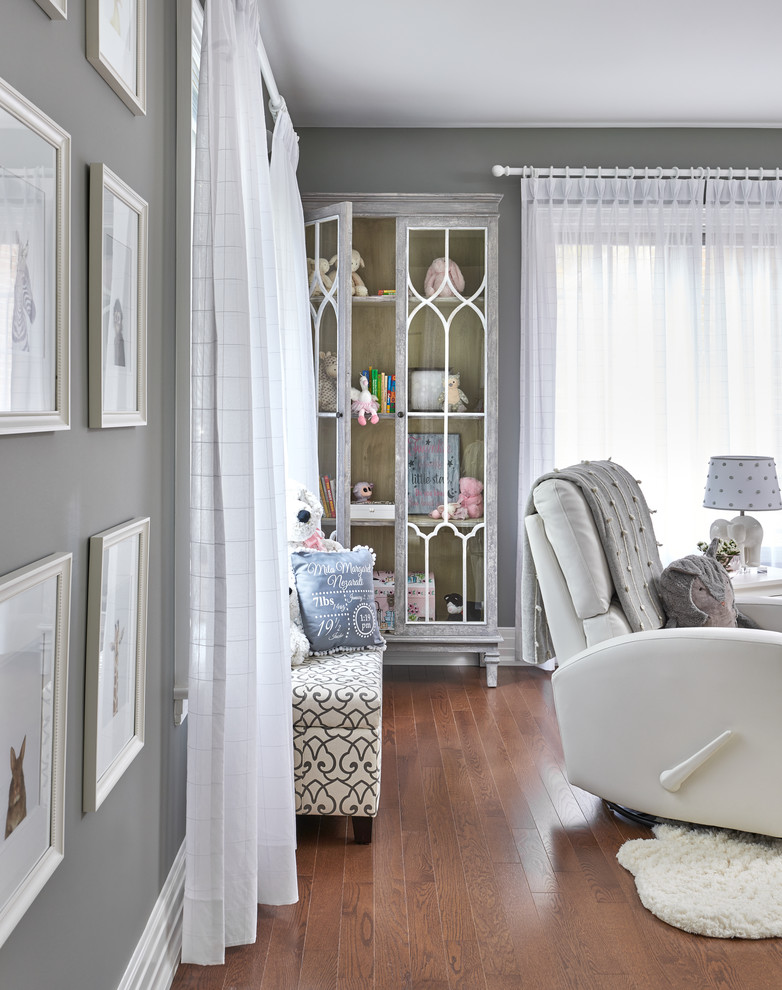Medium sized traditional nursery for girls in Toronto with grey walls.