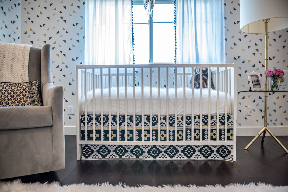This is an example of a small contemporary nursery for girls in Phoenix with multi-coloured walls and dark hardwood flooring.