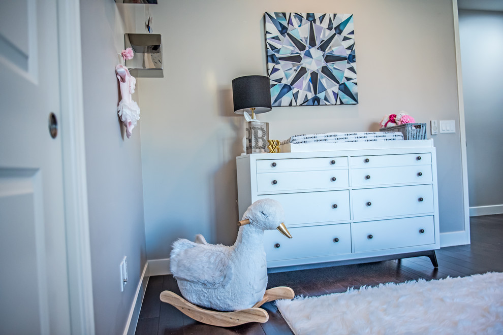 Design ideas for a small contemporary nursery for girls in Phoenix with multi-coloured walls and dark hardwood flooring.