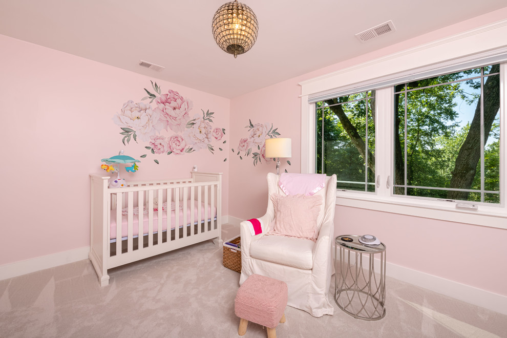 Mid-sized elegant girl carpeted and beige floor nursery photo in DC Metro with pink walls