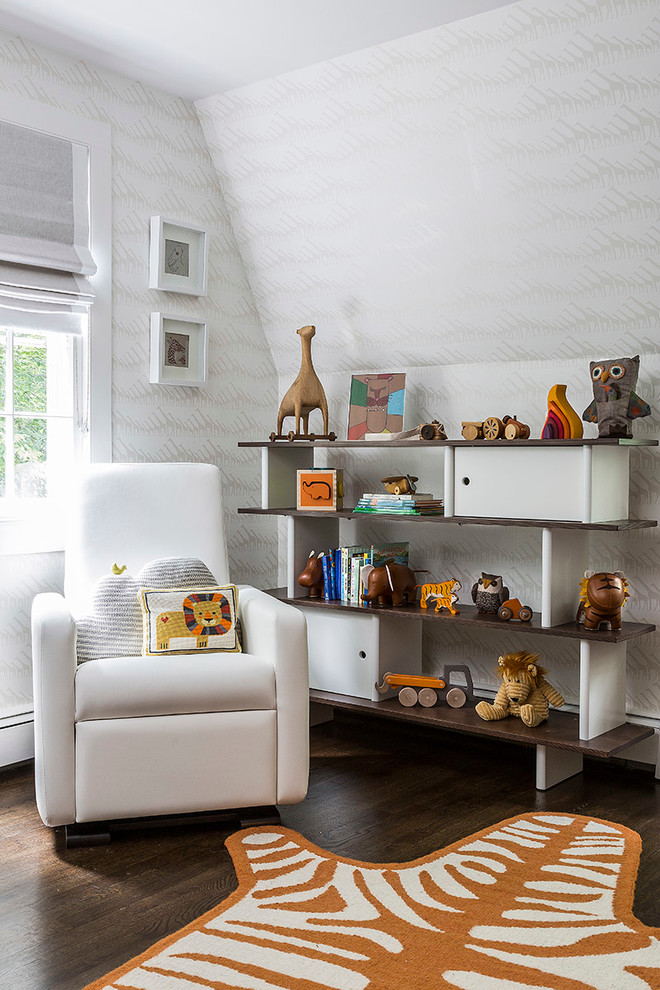 This is an example of a traditional gender neutral nursery in New York with grey walls and dark hardwood flooring.