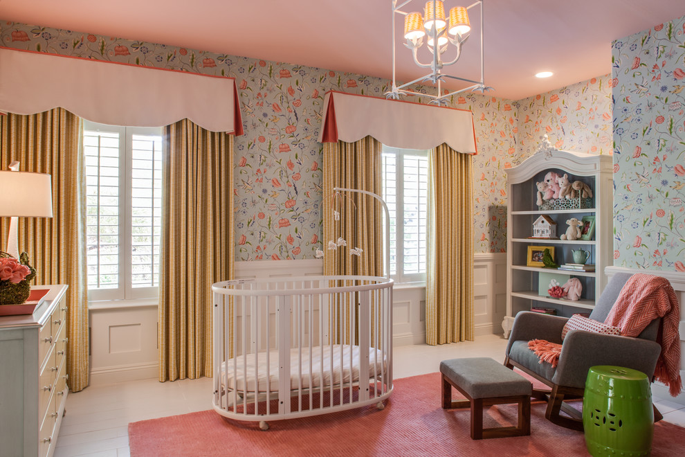 This is an example of a classic nursery for girls in Las Vegas with multi-coloured walls, painted wood flooring, pink floors and a chimney breast.