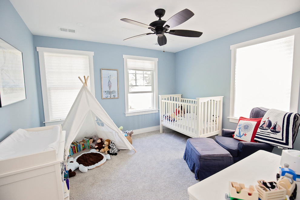 Design ideas for a medium sized rural gender neutral nursery in Baltimore with blue walls, carpet and brown floors.