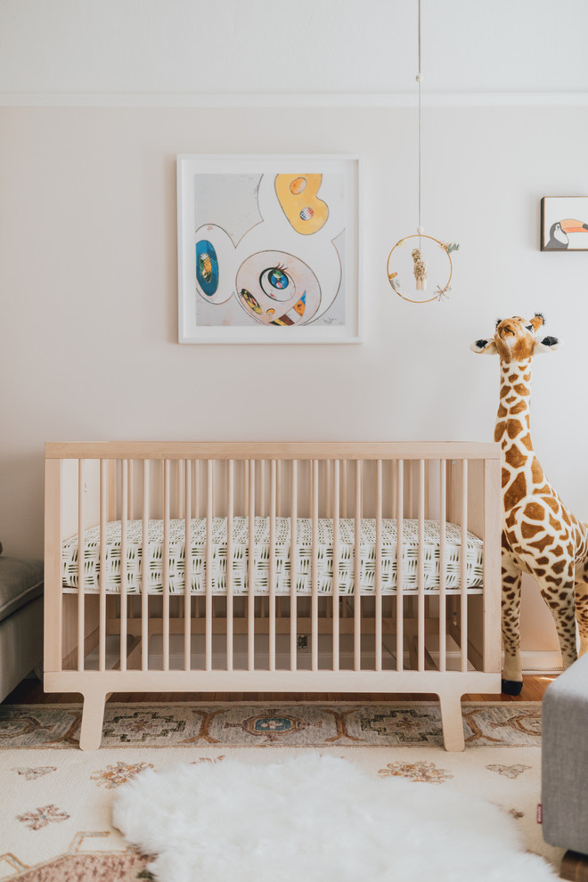 Design ideas for a medium sized bohemian gender neutral nursery in Los Angeles with white walls and medium hardwood flooring.