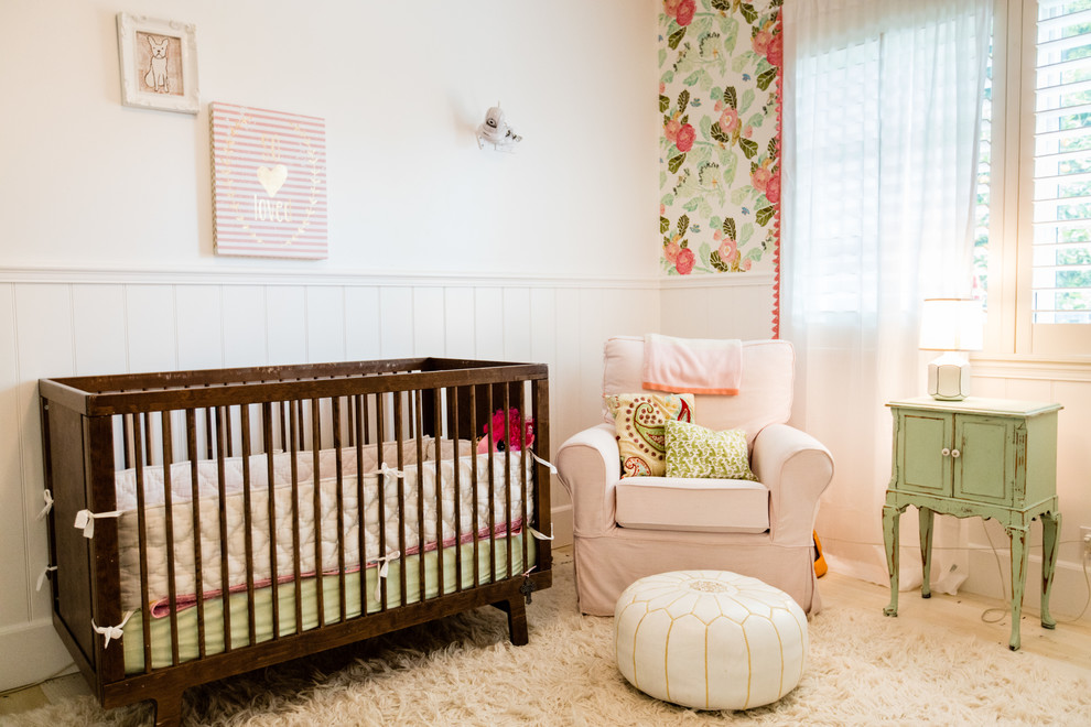 Photo of a romantic nursery in Orange County with white floors and a dado rail.