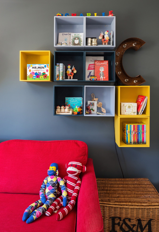 This is an example of a midcentury nursery for boys in London with grey walls.