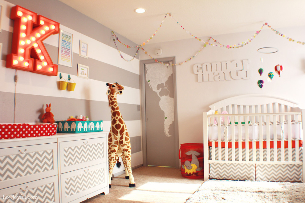 Example of a trendy gender-neutral carpeted nursery design in Orange County with gray walls