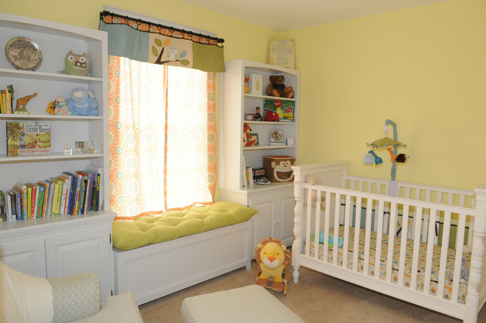 Modelo de habitación de bebé neutra clásica renovada de tamaño medio con paredes amarillas, moqueta y suelo beige
