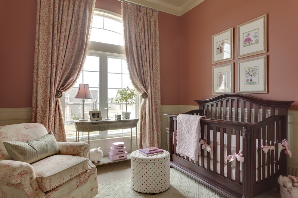 Nursery - mid-sized traditional girl carpeted nursery idea in Kansas City with pink walls
