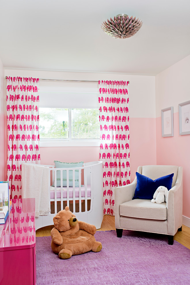 Design ideas for a classic nursery for girls in Toronto with pink walls.