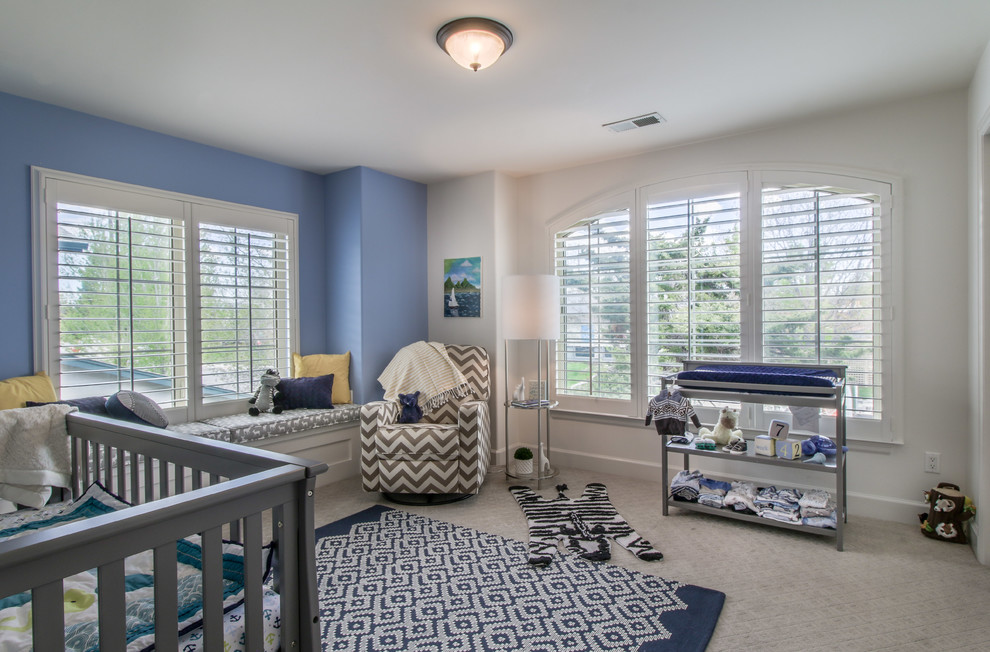 Nursery - small transitional boy carpeted and beige floor nursery idea in Denver with blue walls