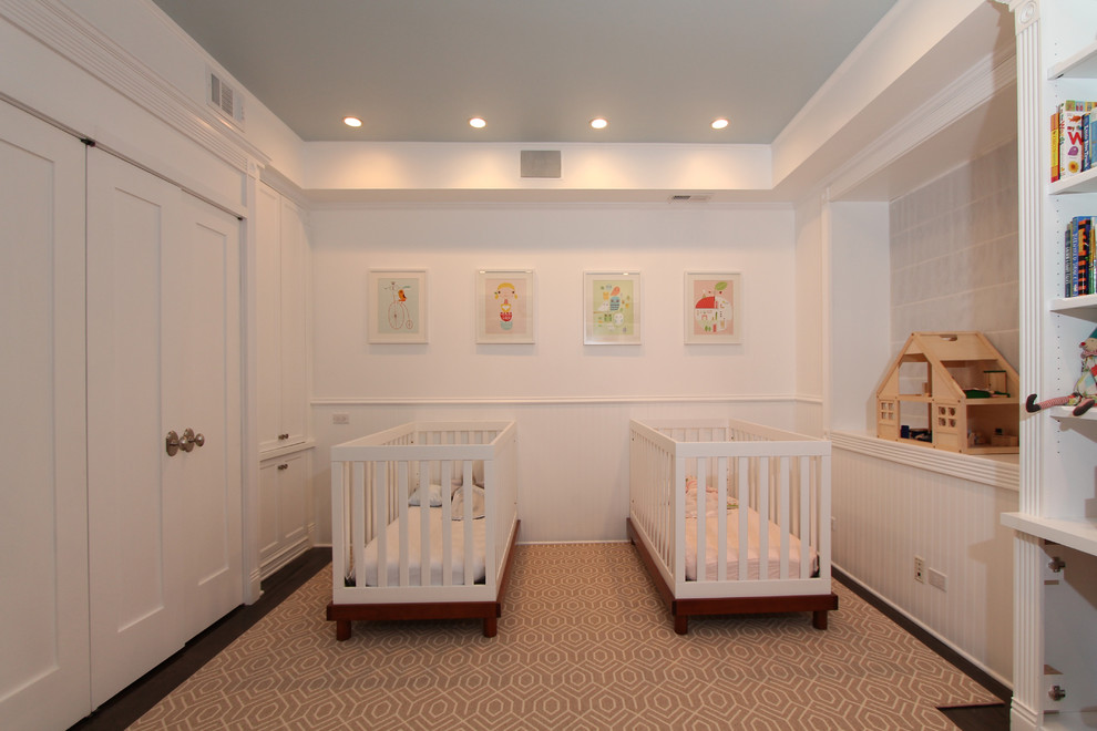 Mid-sized elegant gender-neutral dark wood floor nursery photo in Chicago with white walls