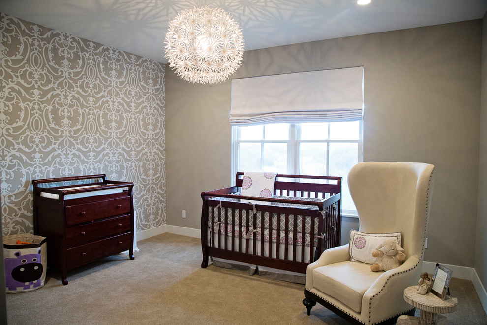 Traditional gender neutral nursery in Cedar Rapids with grey walls, carpet, grey floors and a feature wall.