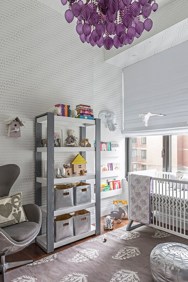 Imagen de habitación de bebé neutra contemporánea con paredes grises y suelo de madera oscura