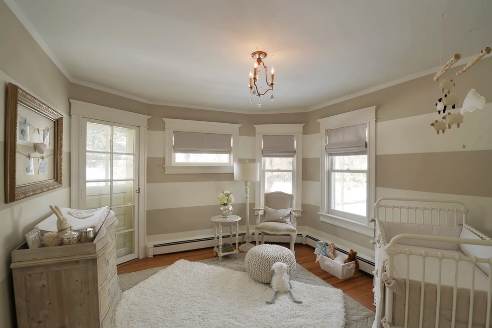 Inspiration for a small timeless gender-neutral medium tone wood floor nursery remodel in New York with white walls