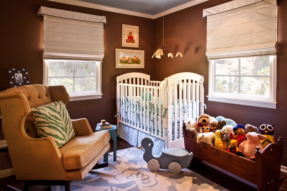 Example of a transitional gender-neutral dark wood floor nursery design in Los Angeles with brown walls