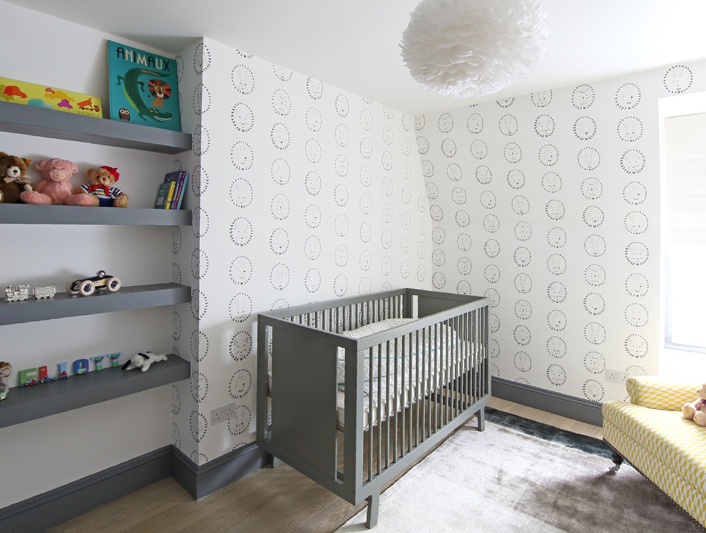 Inspiration for a traditional gender neutral nursery in London with multi-coloured walls and light hardwood flooring.