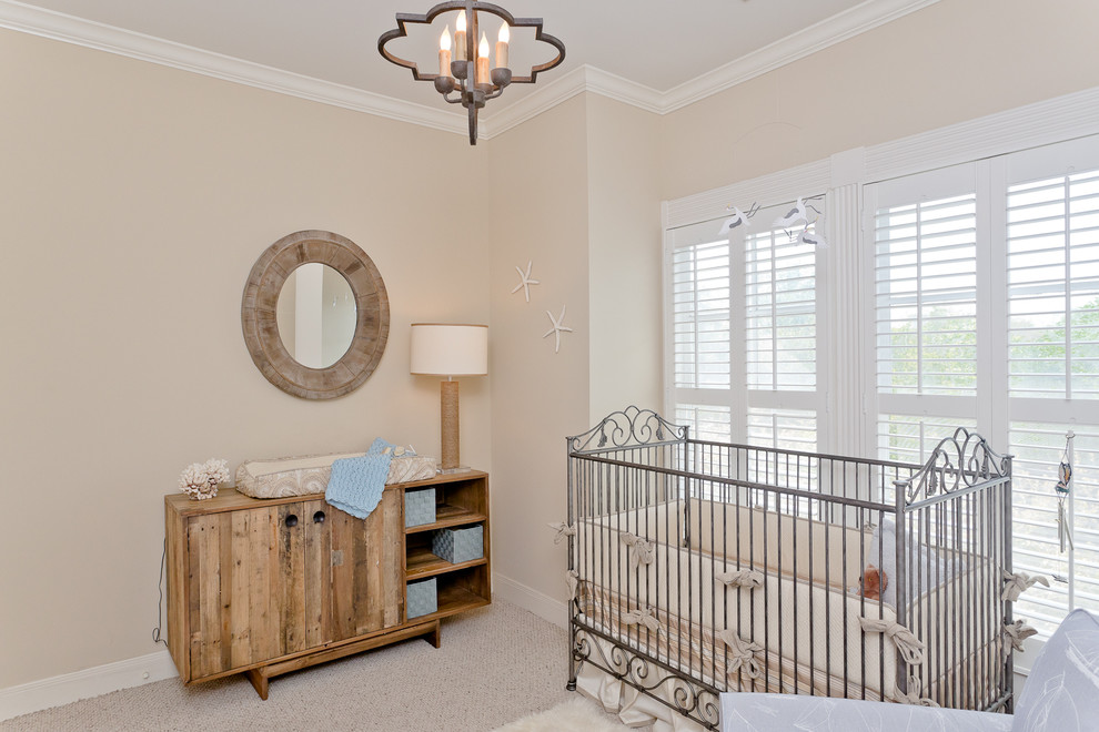 Small beach style gender-neutral carpeted nursery photo in Houston with beige walls