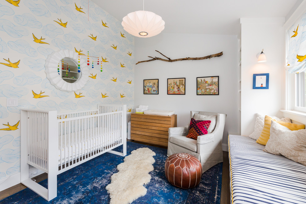 Photo of a medium sized classic nursery for boys in Boston with white walls, dark hardwood flooring, brown floors and a feature wall.